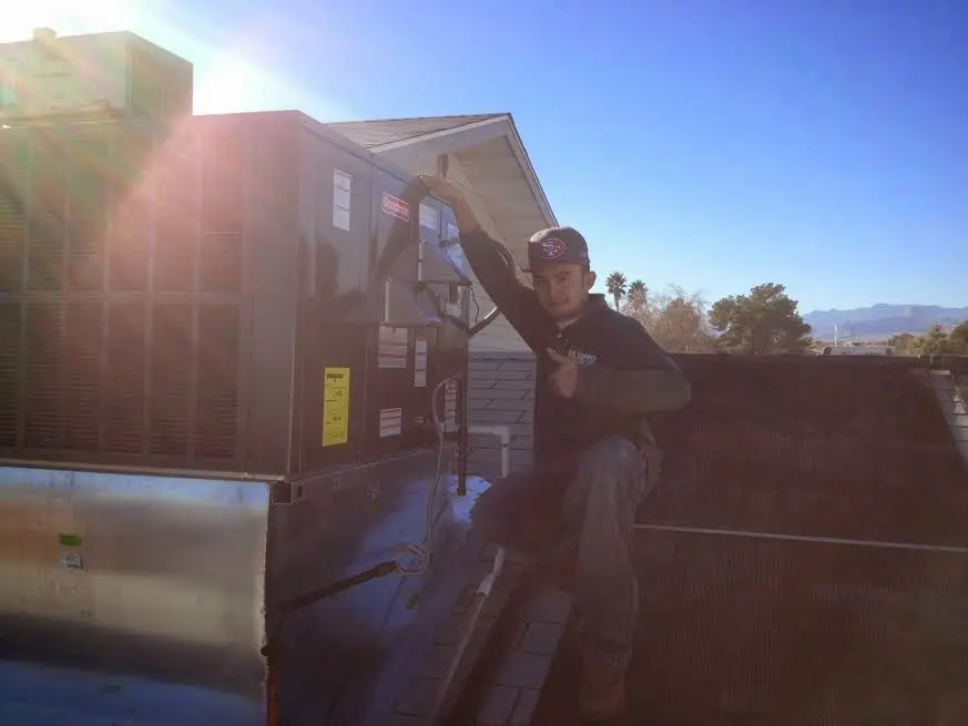 HVAC technician performing HVAC Inspection on a rooftop unit in Lemon Hill
